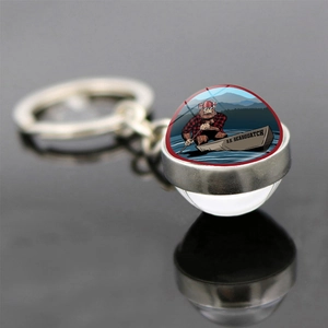Double-sided glass ball keychain featuring Bigfoot rowing boat S.S. Seasquatch illustration