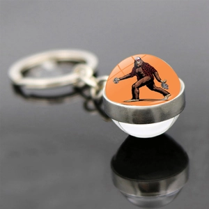 Bigfoot keychain with double-sided glass dome and USA hat illustration on orange background