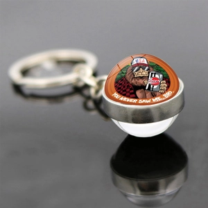 Bigfoot keychain with glass ball pendant featuring a cartoon monster and Beer graphic