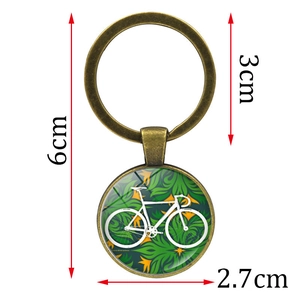 Vintage bronze bicycle glass pendant keychain with dimensions 6cm length and 2.7cm pendant