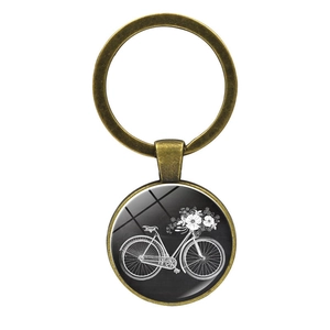 Macro detail of bronze vintage bicycle and flower basket motif under glass dome