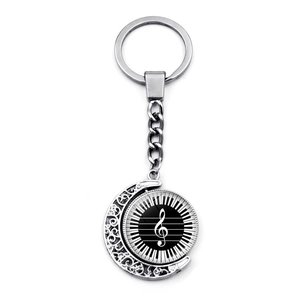 Detailed macro view of the rotating double-sided musical piano key and clef pendant