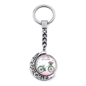 Retro crescent moon keychain with double-sided rotating bicycle and floral glass pendant