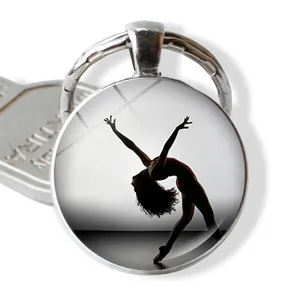 Ballerina silhouette glass dome keychain with elegant artistic gymnastics athlete pattern