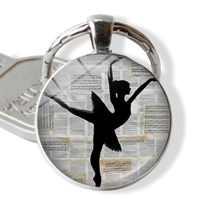 Ballerina silhouette keychain with vintage musical notes in a silver glass dome pendant