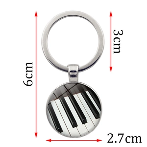 Silver metal heart piano keys keychain with dimensions 6cm length and 2.7cm pendant