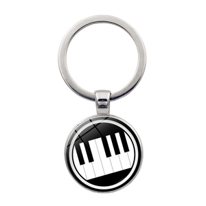Detailed close-up of a silver music keychain featuring a heart-shaped piano key pattern