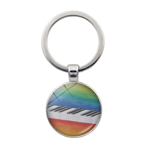 Close-up of heart piano key pendant with rainbow keyboard art on a silver keychain