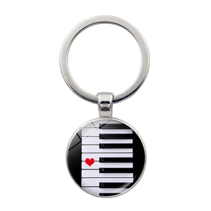 Piano keys keychain with a red heart on silver round pendant for music lovers