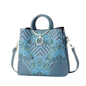 Lake blue embroidered shoulder bag with traditional Chinese wave patterns and metal ring