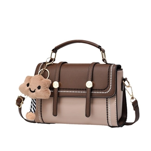 Sac à main rétro bicolore marron et beige avec breloque en peluche et bandoulière