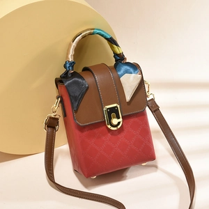 Fashionable red quilted crossbody bag with brown flap and silk scarf handle accent