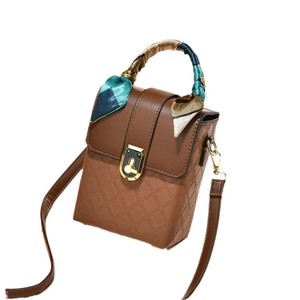 Quilted brown crossbody phone bag with a silk scarf handle and golden twist lock