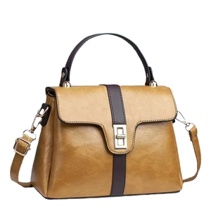 Retro bruine leren tote bag met patchwork strepen en een gouden metalen sluiting
