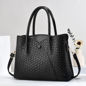 Elegant black woven leather tote bag with stone texture, dual handles and gold hardware