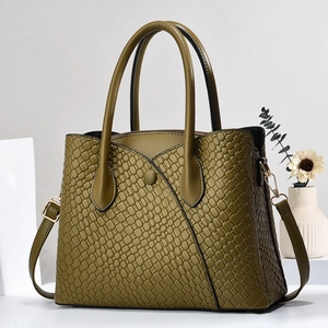 Detailed view of olive green tote bag with crocodile pattern and golden hardware
