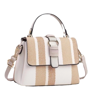 Chic beige striped tote bag with leather trim and adjustable shoulder strap, side view