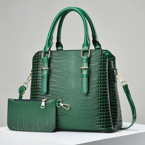 Macro detail of dark green faux crocodile leather tote and matching coin purse