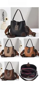 Detail view of stone pattern bucket bag showing internal pockets and multi-color options