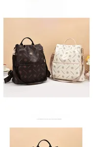 Close-up of printed leather backpacks in dark brown and cream with gold flower hardware