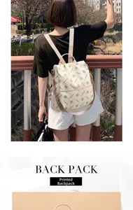 Outdoor shot of beige printed faux leather backpack with adjustable straps on model