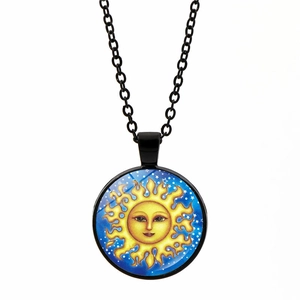 Detail of artistic celestial sun pendant with star pattern and black metal chain
