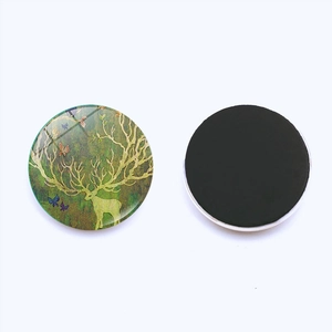 Close-up of 25mm round Christmas elk glass magnet with strong black magnetic backing