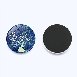 Detail of round Christmas elk glass fridge magnets with back magnetic surface view