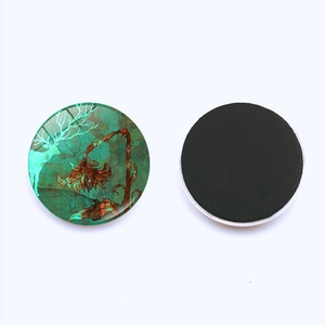 Close-up of front and back of round magnetic fridge sticker with vintage elk and sunflower