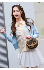 Modische braune Satteltasche mit Monogramm-Muster von Model im Outdoor-Streetstyle gehalten