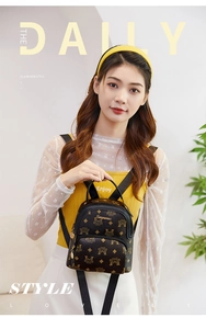 Mini brown retro monogram backpack with adjustable straps worn by a model in warm light