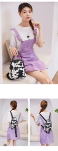 Detailed views of a mini cow print backpack with adjustable straps and golden zippers
