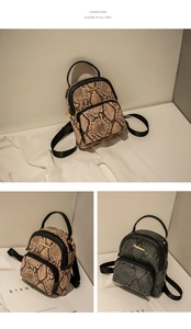 Detail of vintage snake print mini backpack with textured leather and metal zippers