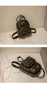 Macro detail of brown mini backpack with yellow pattern and golden hardware zipper