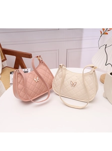 Detailed view of quilted leather crescent bags with butterfly clasps in pink and cream