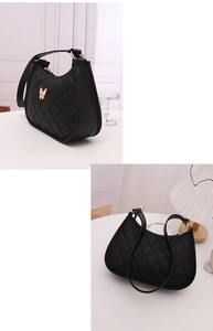 Detail of black quilted hobo bag with butterfly metal accent and elegant crescent shape