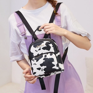 Mini cow print backpack in PU leather with black straps and round zipper pendant