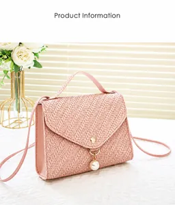Detail of pink woven texture crossbody bag with elegant pearl pendant and gold hardware