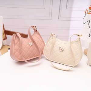 Pink and cream quilted faux leather butterfly shoulder bags in a cozy home setting