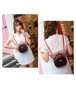 Mini round cherry backpack for women with black litchi pattern and red straps