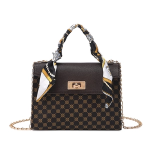 Retro brown crossbody handbag with clover pattern and silk scarf handle detail