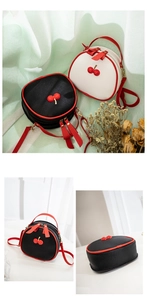 Macro detail of lychee texture small crossbody bag with 3D cherry and red edge finishing
