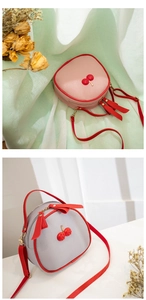 Close-up of litchi grain texture and cherry decor on cute pink and grey crossbody bags