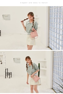 Detailed view of pink crocodile-embossed handbag with elegant handles and long strap