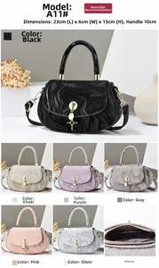 Detail view of stylish marbled texture handbag with star pendant and detachable strap