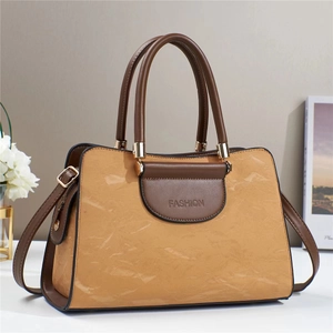 Two-tone macaron handbag with pleated texture and adjustable strap in studio setting