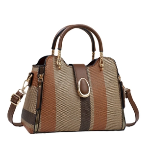 Vintage gestreifte Beuteltasche mit braunem Lederbesatz und goldenem Griff auf Weiß