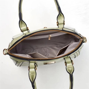 Top view of mint green handbag interior showing grey lining and zipper compartments