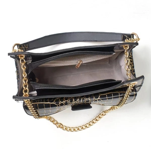 Top view of black crocodile pattern bag showing spacious interior with zipper compartment