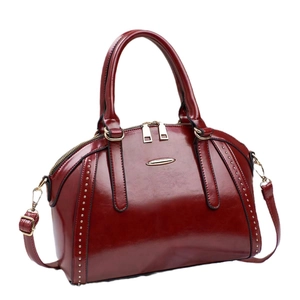 Elegant wine red patent leather shell handbag with golden rivets and dual handles